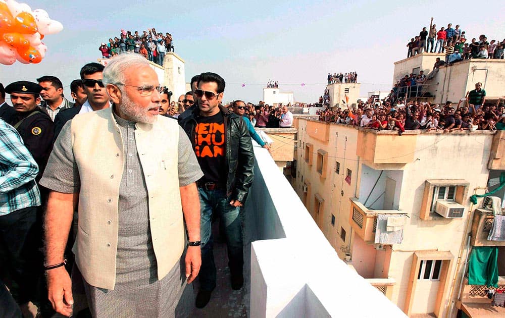 Gujarat Chief Minister and BJP`s PM candidate Narendra Modi with Bollywood actor Salman Khan during the Uttarayan Festival in Ahmedabad.