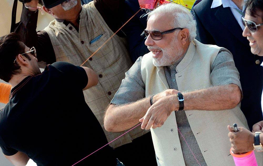 Gujarat Chief Minister and BJP`s PM candidate Narendra Modi with Bollywood actor Salman Khan during the Uttarayan Festival in Ahmedabad.
