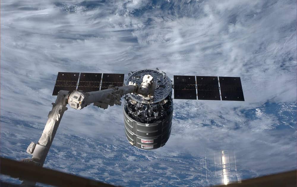 This photo provided by NASA, the Cygnus resupply spacecraft is captured by the robotic arm onboard the International Space Station.