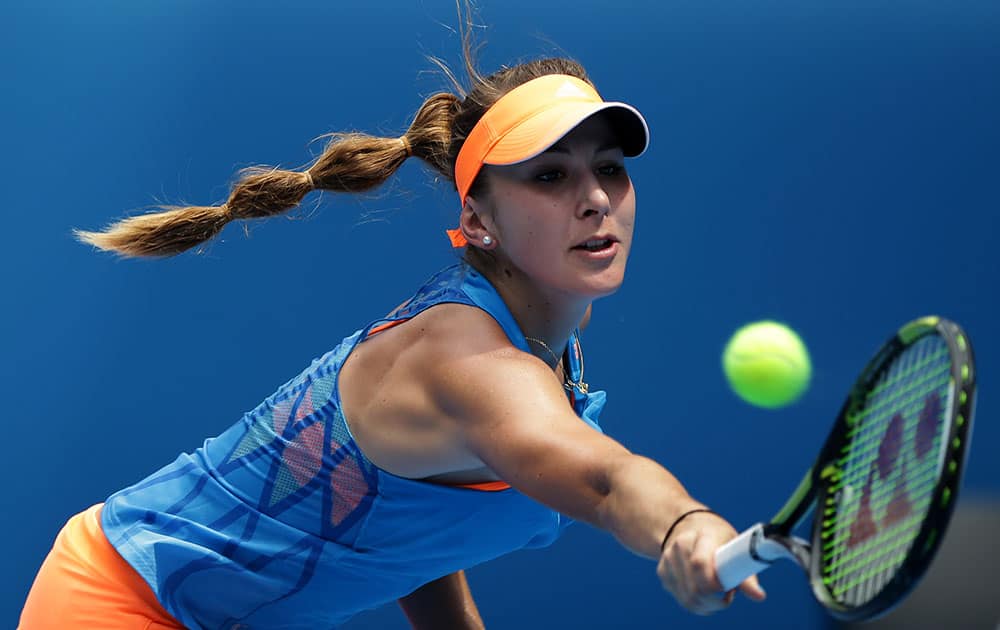 Belinda Bencic of Switzerland makes a backhand return to Li Na of China during their second round match at the Australian Open tennis championship in Melbourne.