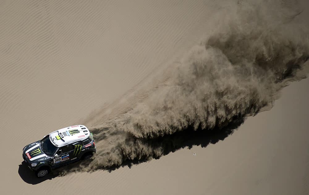 Mini driver Nasser Al-Attiyah of Qatar and co-pilot Lucas Cruz of Spain race through the dunes during the ninth stage of the Dakar Rally between the cities of Calama and Iquique, Chile.