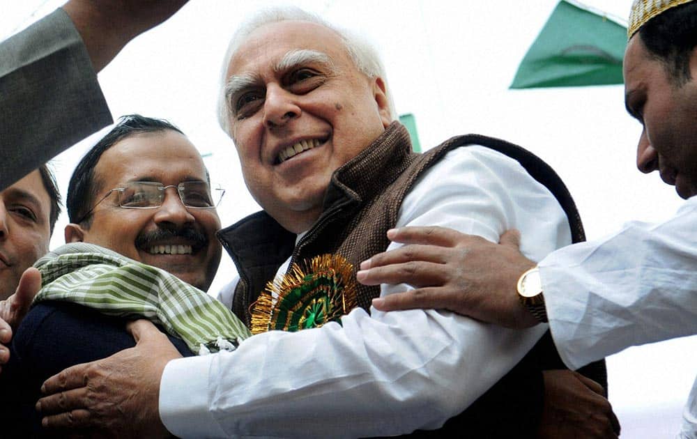 Union Minister Kapil Sibal and Delhi Chief Minister Arvind Kejriwal hug each other during an Eid Milad-un-Nabi procession in New Delhi.
