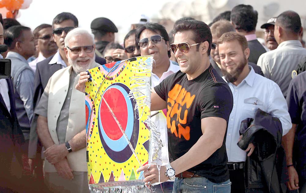 Bollywood actor Salman Khan prepares to fly a kite as Gujarat state Chief Minister Narendra Modi watches during the kite festival Uttarayan in Ahmedabad. Salman khan is in the city to promote his upcoming movie Jai Ho.