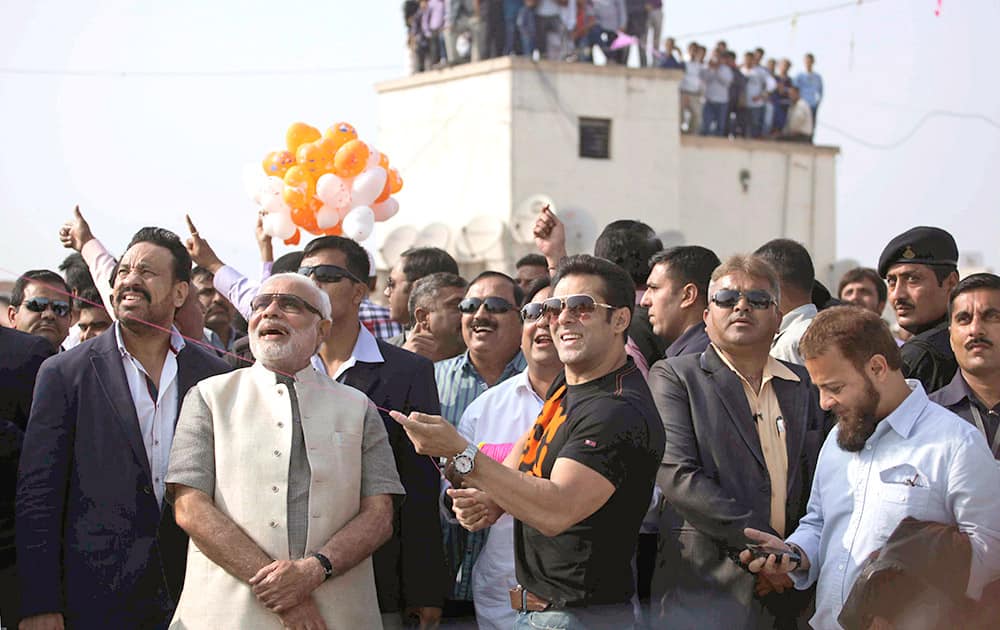 Gujarat state Chief Minister Narendra Modi watches Bollywood actor Salman Khan fly a kite during the kite festival Uttarayan in Ahmedabad.