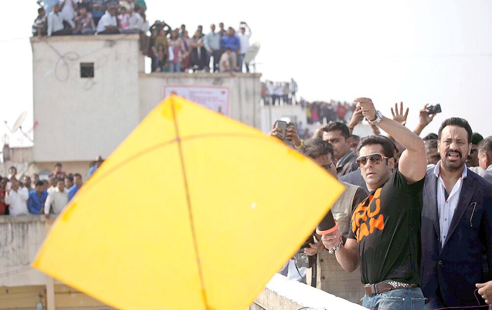 Bollywood actor Salman Khan flies a kite during the kite festival Uttarayan in Ahmedabad. Khan is in the city to promote his upcoming movie