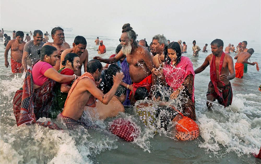 Pilgrims seeks blessings from a Sadhu after a holy dip at Sagar Island on the occassion of `Makarsankranti`.