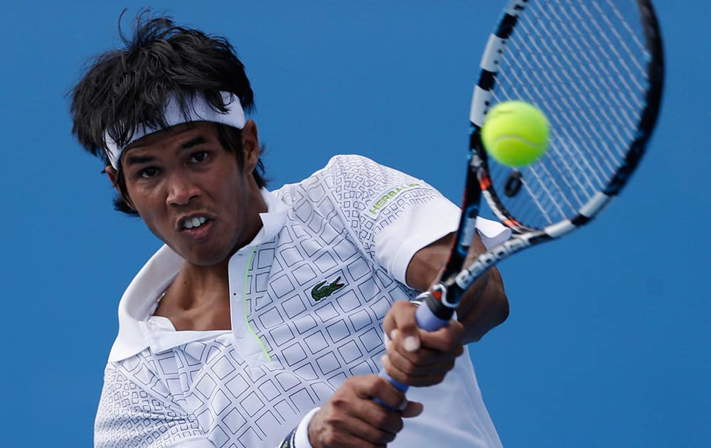 Somdev Devvarman of India makes a backhand return to Feliciano Lopez of Spain during their first round match at the Australian Open tennis championship in Melbourne.
