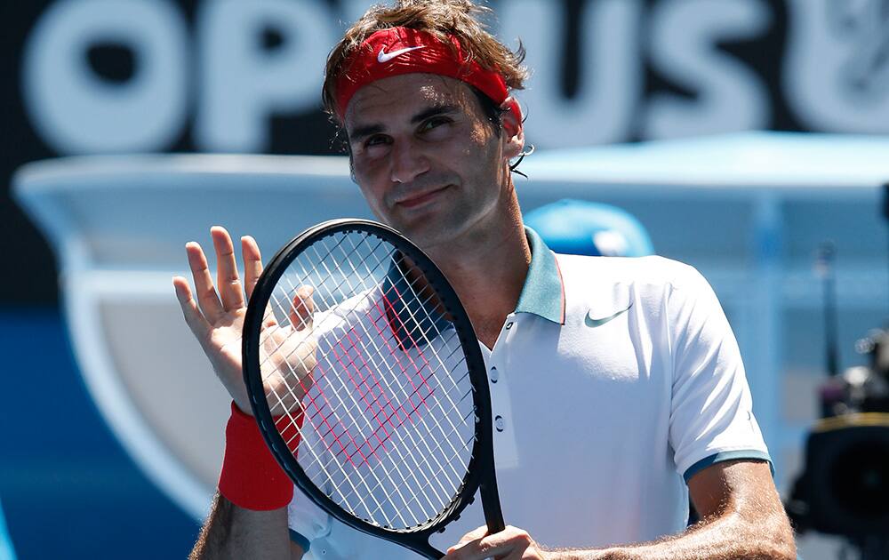 Roger Federer of Switzerland celebrates his win over James Duckworth of Australia after their first round match at the Australian Open tennis championship in Melbourne, Australia.