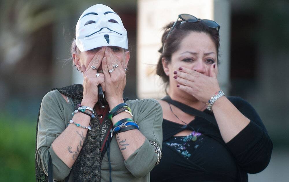 Shocked supporters of Kelly Thomas react, in Santa Ana, Calif., after the `not guilty` verdicts in his beating death outside the Santa Ana Courthouse.