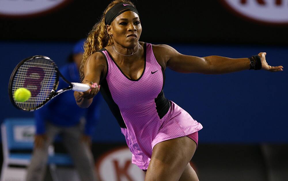 Serena Williams of the United States hits a forehand return to Ashleigh Barty of Australia during their first round match at the Australian Open tennis championship in Melbourne, Australia.