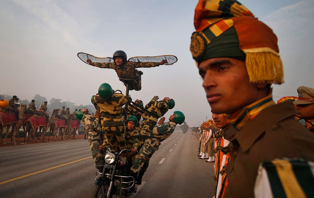 Indian soldiers perform on a moving motorcycle during Republic Day Parade rehearsals in New Delhi.