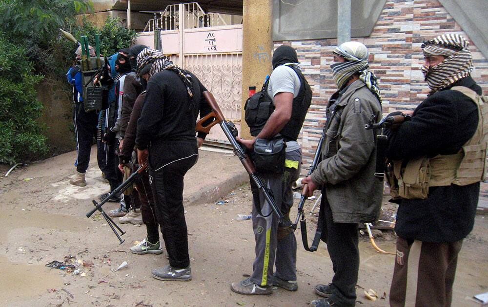 Gunmen patrol in Fallujah, 40 miles (65 kilometers) west of Baghdad, Iraq. Fighting between security forces and al-Qaida-linked militants in Iraq`s Sunni-dominated Anbar province has killed at least 60 people over the past two weeks, an official said Saturday. International observers have warned of shortages of food, fuel and other necessities, particularly in Fallujah.