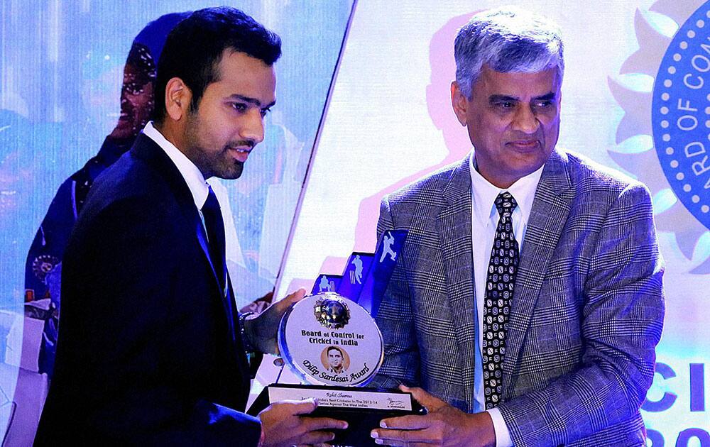 BCCI Secretary Sanjay Patel felicitates Indian cricketer Rohit Sharma with BCCI awards in Mumbai.