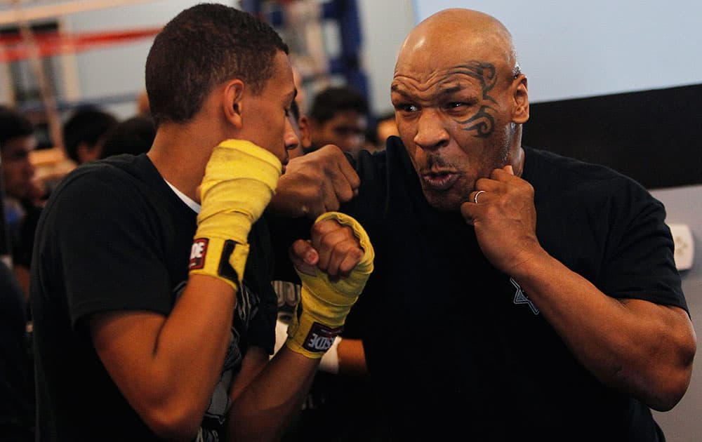 Former heavyweight champion Mike Tyson spars with Gabriel Blake while teaching a boxing clinic to a group of children at the Richard Steele Boxing Club in North Las Vegas.