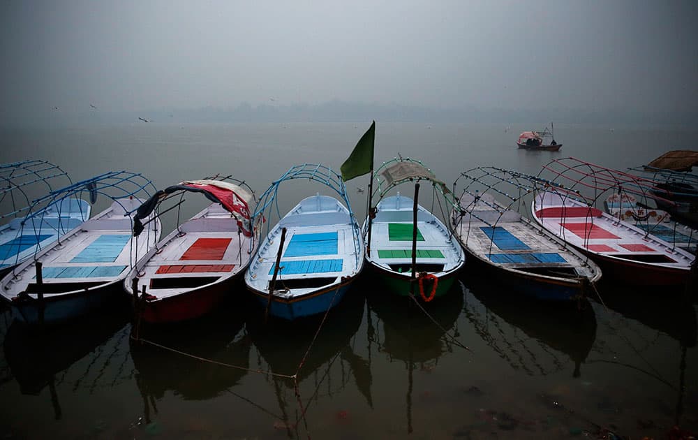 Boats stand parked at the Sangam, the confluence of rivers Ganges, Yamuna and mythical Saraswati on a cold day in Allahabad, in the northern Indian state of Uttar Pradesh