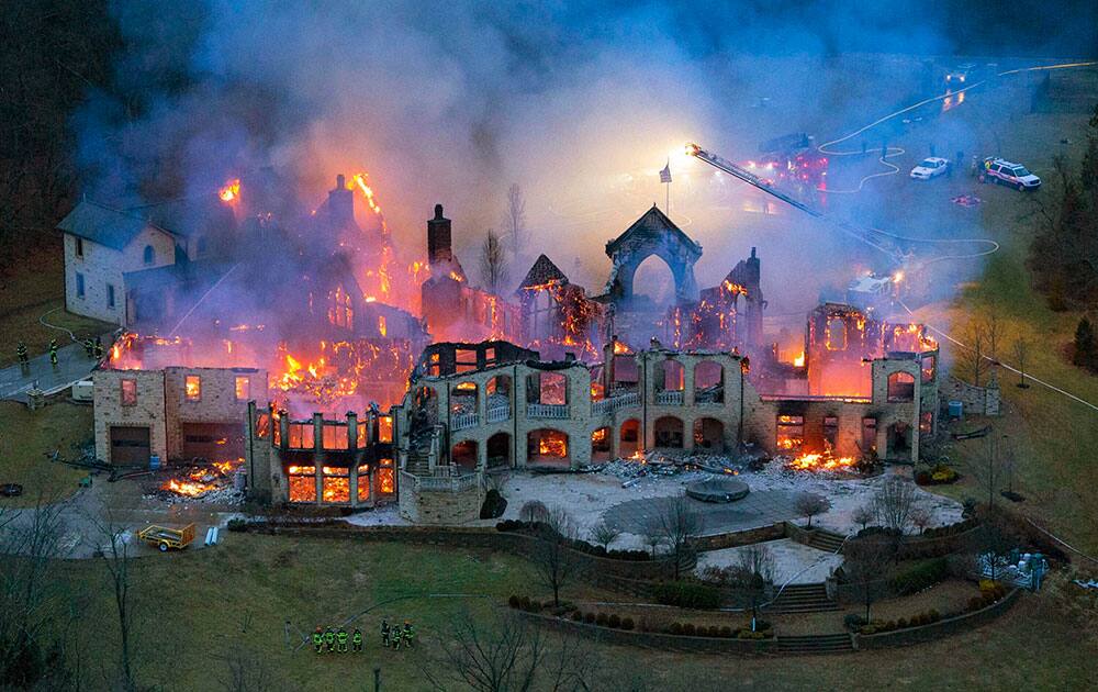 Firefighters battle a structure fire in the 9600 block of Cunningham Road in Indian Hill, Ohio.
