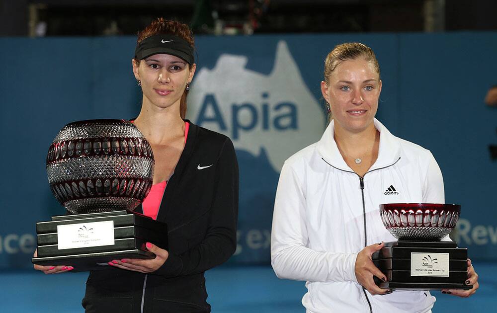Tsvetana Pironkova of Bulgaria, left, and Angelique Kerber of Germany poses for a photo after their finals match during the Sydney International Tennis Tournament in Sydney.