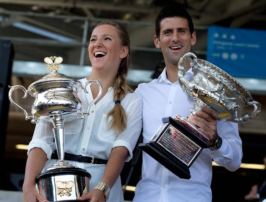 Defending champions Victoria Azarenka of Belarus and Serbia`s Novak Djokovic pose with their trophies prior to the the official draw of the Australian Open tennis championship in Melbourne Australia.