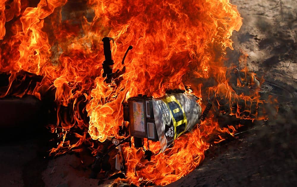 The Honda motorcycle of Paulo Goncalves of Portugal burns during the fifth stage of the Dakar Rally between the cities of Chilecito and San Miguel de Tucuman, Argentina.