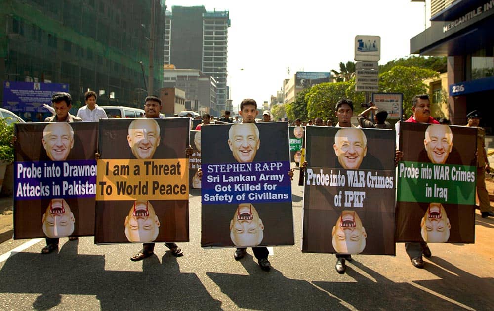 Members of Sri Lanka`s pro-government political party, National Freedom Front, hold placards carrying portraits of Stephen J. Rapp, an ambassador-at-large in the Office of Global Criminal Justice during a protest out side the US Embassy in Colombo, Sri Lanka.