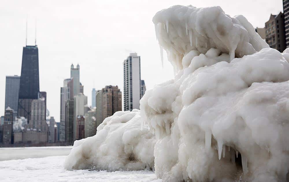 The Chicago skyline is seen behind a large chunk of ice near North Avenue Beach as cold temperatures remain with wind chills nearing minus 30 Fahrenheit.