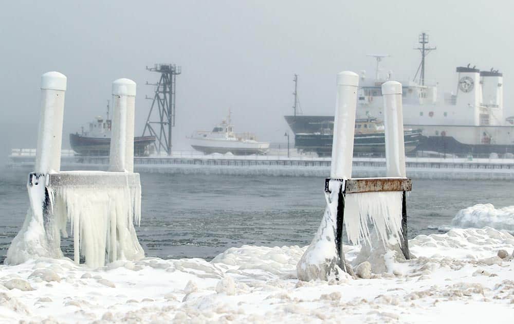 Ice forms on parts of a dock at West Bay Beach, a Holiday Inn Resort, on West Grand Traverse Bay near the Great Lakes Maritime Academy in Traverse City, Mich.