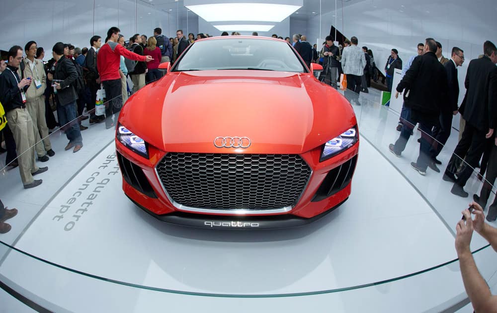 Trade show attendees gather around the Audi Sport quattro laserlight concept car at the International Consumer Electronics Show in Las Vegas.