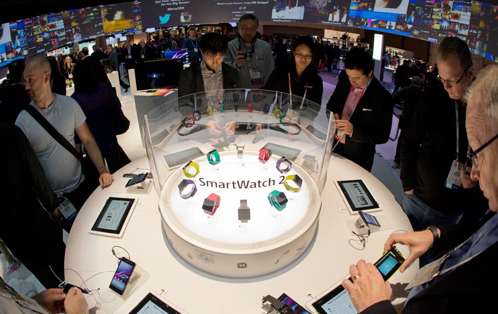 Trade show attendees examine the Sony Smart Watch 2 on display at the International Consumer Electronics Show in Las Vegas. The Android based watch interacts with the user`s smartphone.