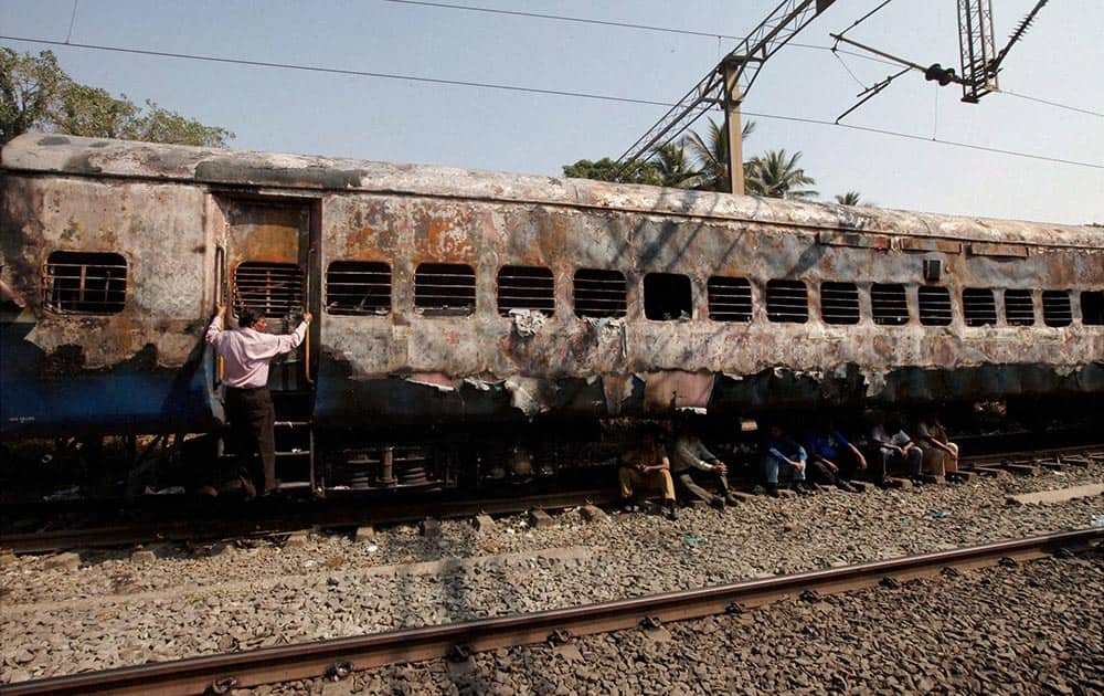 BURNT COACHES OF THE MUMBAI-DEHRADUN EXPRESS WHICH CAUGHT FIRE IN THE WEE HOURS, NEAR DAHANU IN THANE DISTRICT.