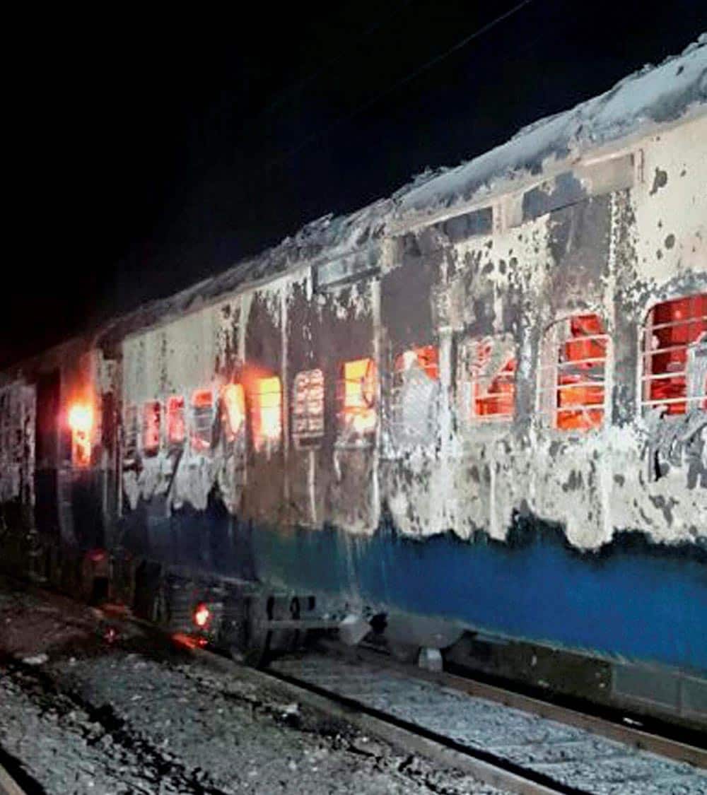Burnt coaches of the Mumbai-Dehradun Express which caught fire in the wee hours, near Dahanu in Thane district.
