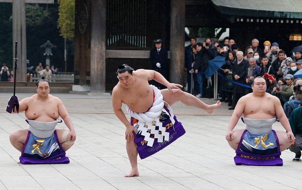Sumo grand champion Harumafuji, of Mongolia performs his ring entry forms to dedicate to the Meiji Shrine in Tokyo.
