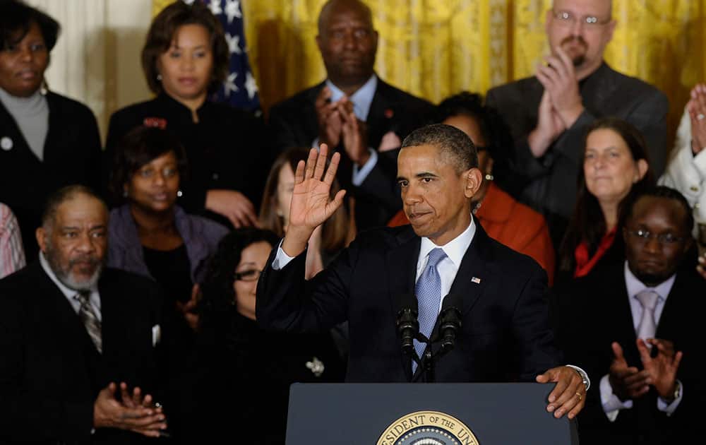 President Barack Obama waves after speaking about unemployment benefits, during an event in the East Room of the White House in Washington.