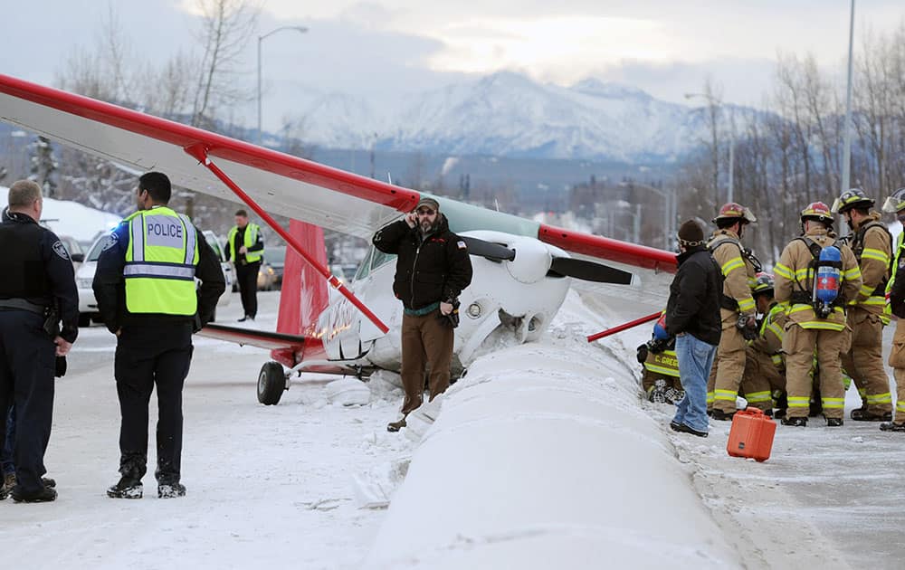 A plane rests in the northbound lane of Boniface Parkway following an emergency landing near Perry Drive south of DeBarr Road in Anchorage, Alaska.