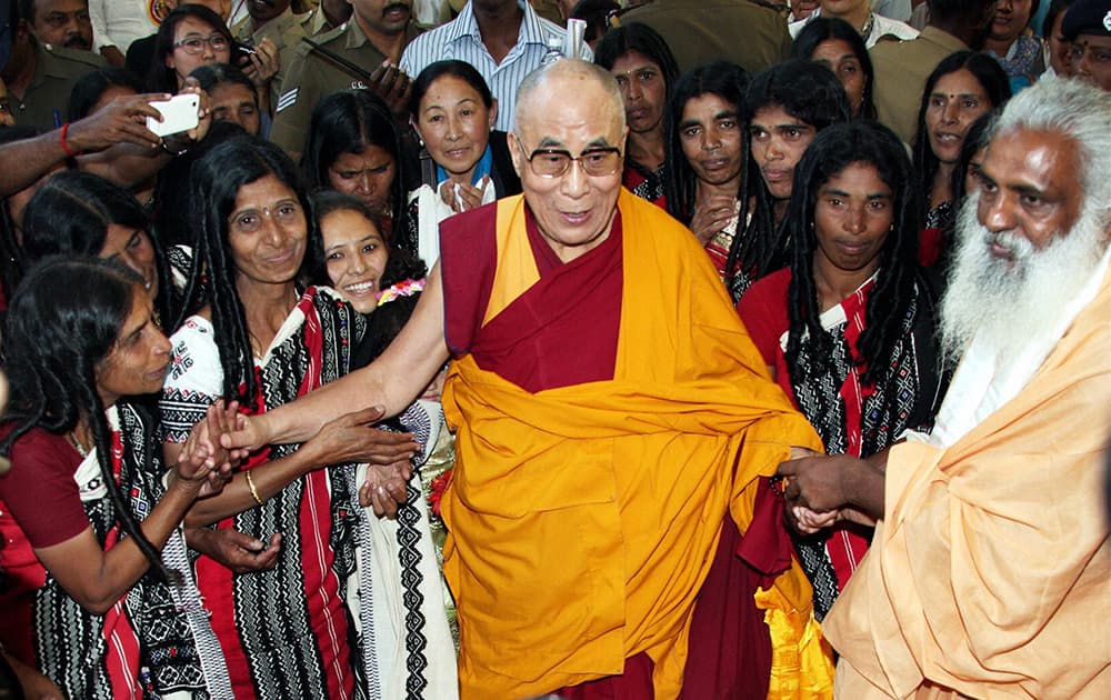 Tibetan Spiritual Guru Dalai Lama interacting with Nilgiri Primitive Tribal people during the 150th birth anniversary celebrations of Swami Vivekananda in Coimbatore.