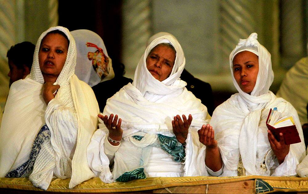 Worshippers pray during Christmas Eve Mass at Cairo’s St. Mark’s Cathedral, seat of the Coptic Orthodox Pope, in Cairo, Egypt.