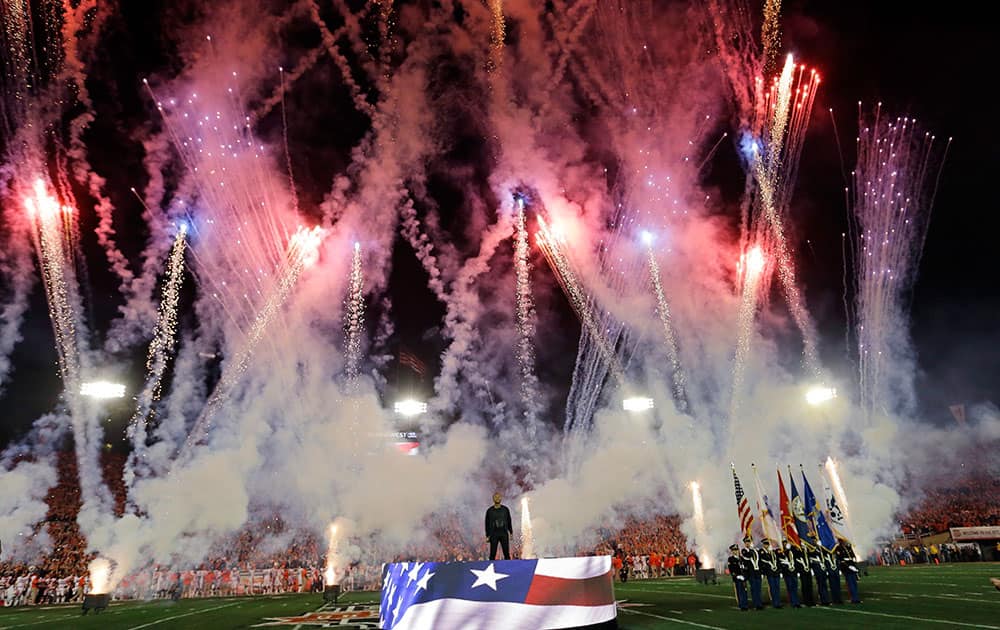 John Legend sings the national anthem before the NCAA BCS National Championship college football game between Auburn and Florida State in Pasadena, Calif.