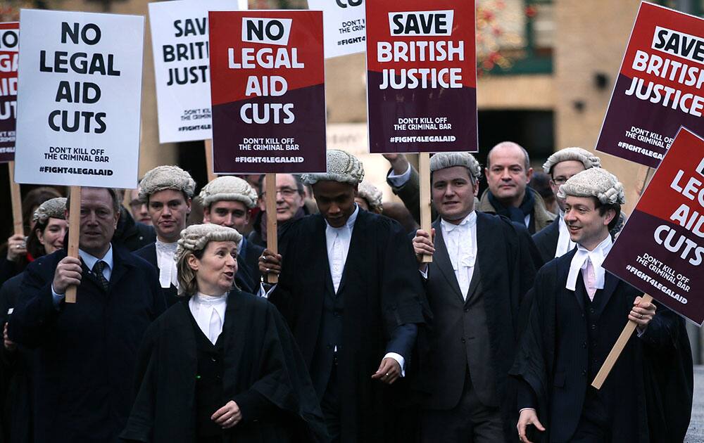 British lawyers protest outside Southwark Crown Court as they demonstrate against British government cuts to legal aid, in London.