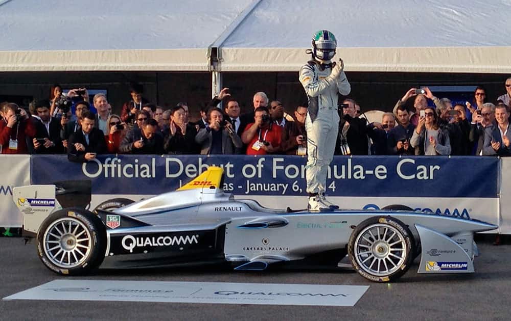 Brazilian Formula One driver Lucas di Grassi stands on a new all-electric race car, the Spark-Renault SRT 01E Formula E, before taking it on a demonstration drive on the grounds of the Mandalay Bay hotel-casino in Las Vegas.