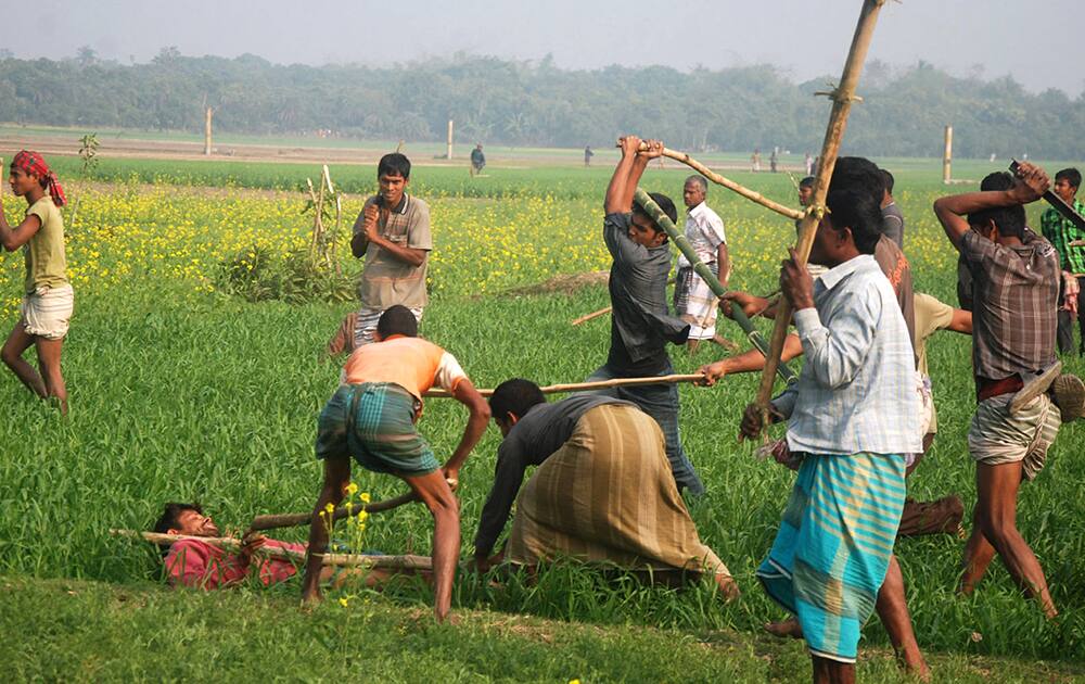 Bangladeshi opposition party activists beat a ruling Awami League party activist during a clash near a polling station in Rajshahi, northwest of Dhaka.