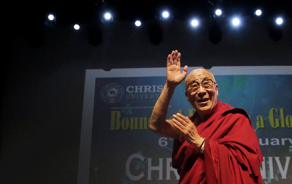 Tibetan spiritual leader the Dalai Lama waves to the audience as he leaves after delivering his lecture on `Bounds of Ethics in a Globalized World` at Christ University in Bangalore.