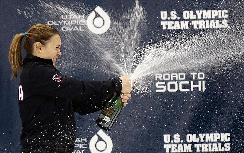 First-place finisher Jessica Smith celebrates on the podium following the women`s 1,000 meters during the US Olympic short track speedskating trials, in Kearns, Utah.