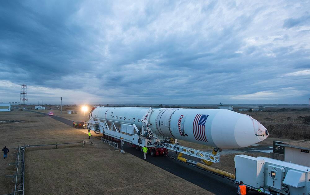 An Orbital Sciences Corporation Antares rocket is seen as it is rolled out to launch Pad-0A at NASA`s Wallops Flight Facility, Wallops Island, Va.