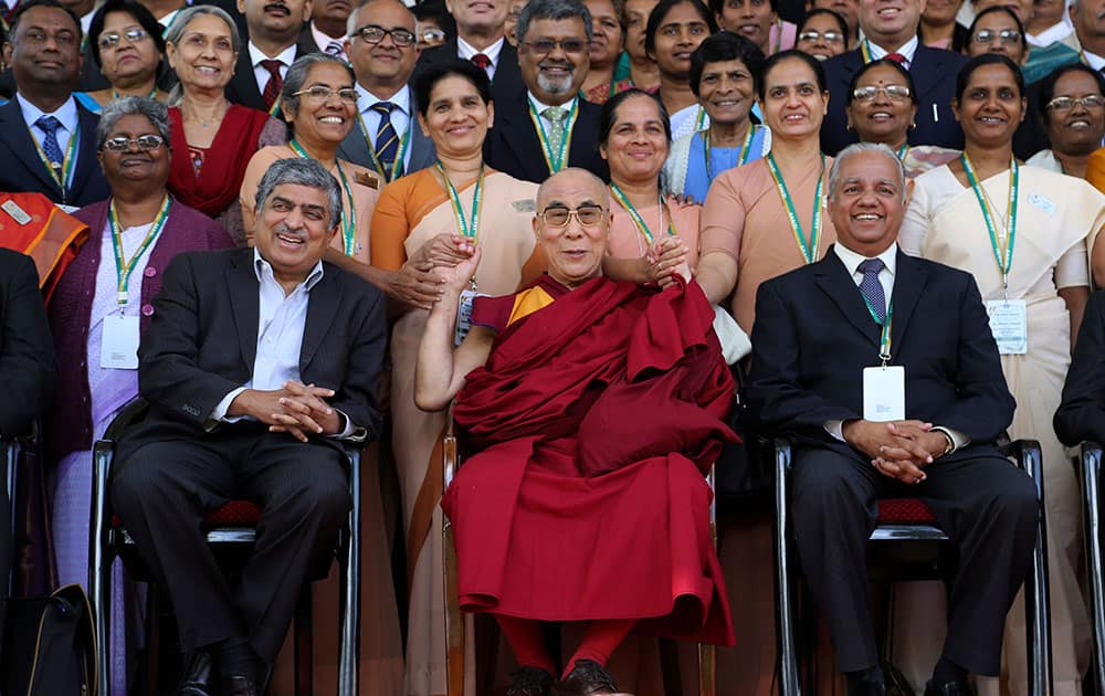 Tibetan spiritual leader the Dalai Lama, seated center, poses for photographs with Unique Identification Authority of India (UIAI) Chairman Nandan Nilekani, seated left, and the delegates at the 92nd annual conference of the Association of Heads of Anglo-Indian Schools in India, in Bangalore, India.