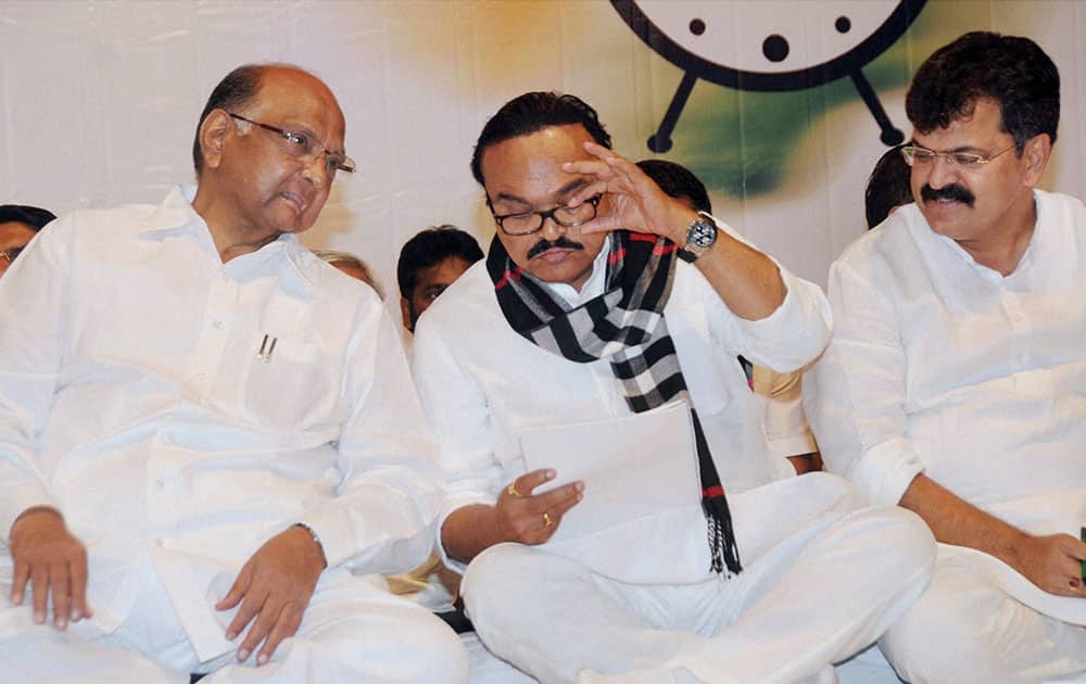 NCP President and Union Agriculture Minister Sharad Pawar with party leaders Chagan Bhujbal and Jitendra Avhad during the party`s Lok Sabha election preparation meeting in Mumbai.