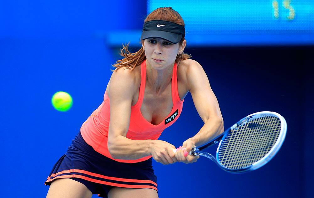 Tsvetana Pironkova of Bulgaria hits a return to Shahar Peer of Israel during their women`s singles match at the Sydney International tennis tournament.