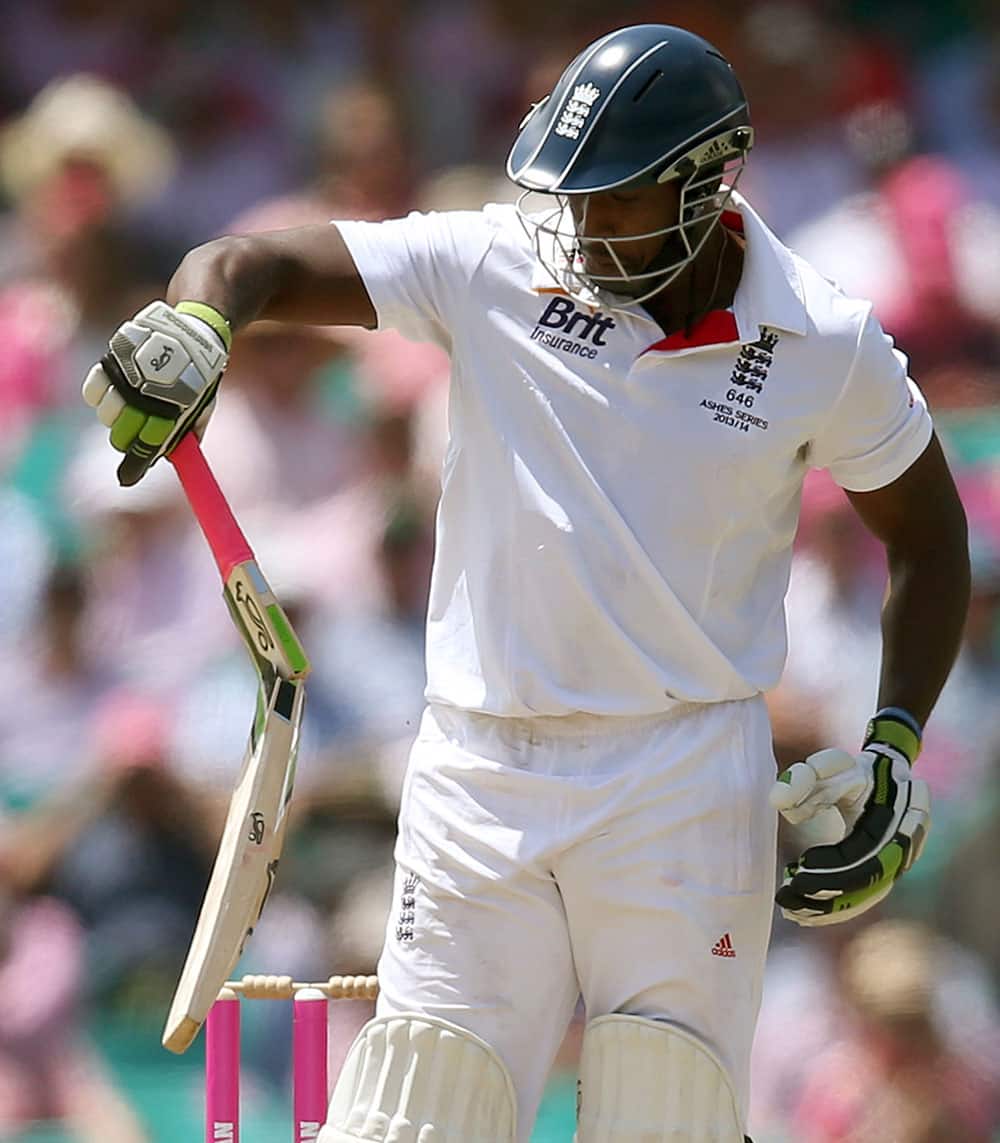 England`s Michael Carberry looks at his bat after it broke while playing Australia on day 3 of their Ashes cricket test match at the Sydney Cricket Ground in Sydney.