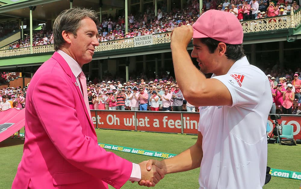 England`s cricket captain Alastair Cook, right, greets former Australian cricketer Glenn McGrath as he hands over a pink baggy cap on Jane McGrath Day on the third day of their Ashes cricket test match against Australia in Sydney.