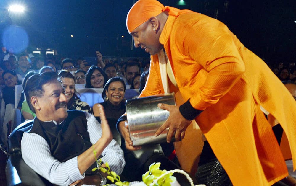 Maharashtra Chief Minister Prithviraj Chavan strokes the drum as artist A Shivamani watches with excitement in Saptrang Mahostav in Mumbai.