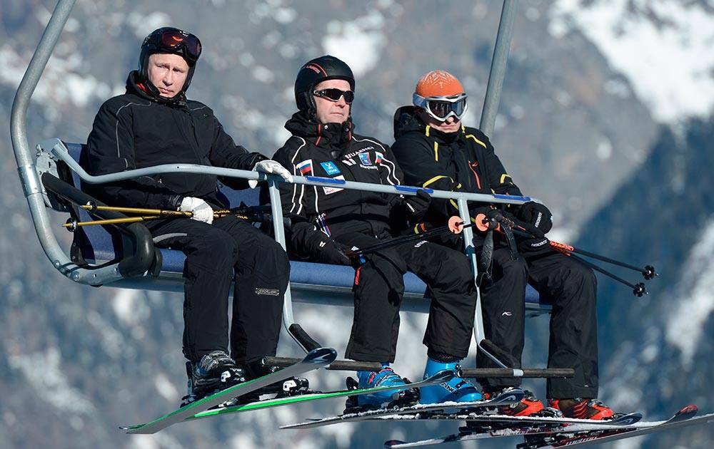 Russian Prime Minister Dmitry Medvedev, centre, and President Vladimir Putin, left, look around whilst sitting on a ski lift at the mountain resort of Krasnaya Polyana near the Black Sea resort of Sochi, southern Russia.