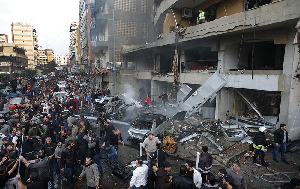 Lebanese citizens gather at the site of a car bomb explosion in a stronghold of the Shiite Hezbollah group at the southern suburb of Beirut, Lebanon.